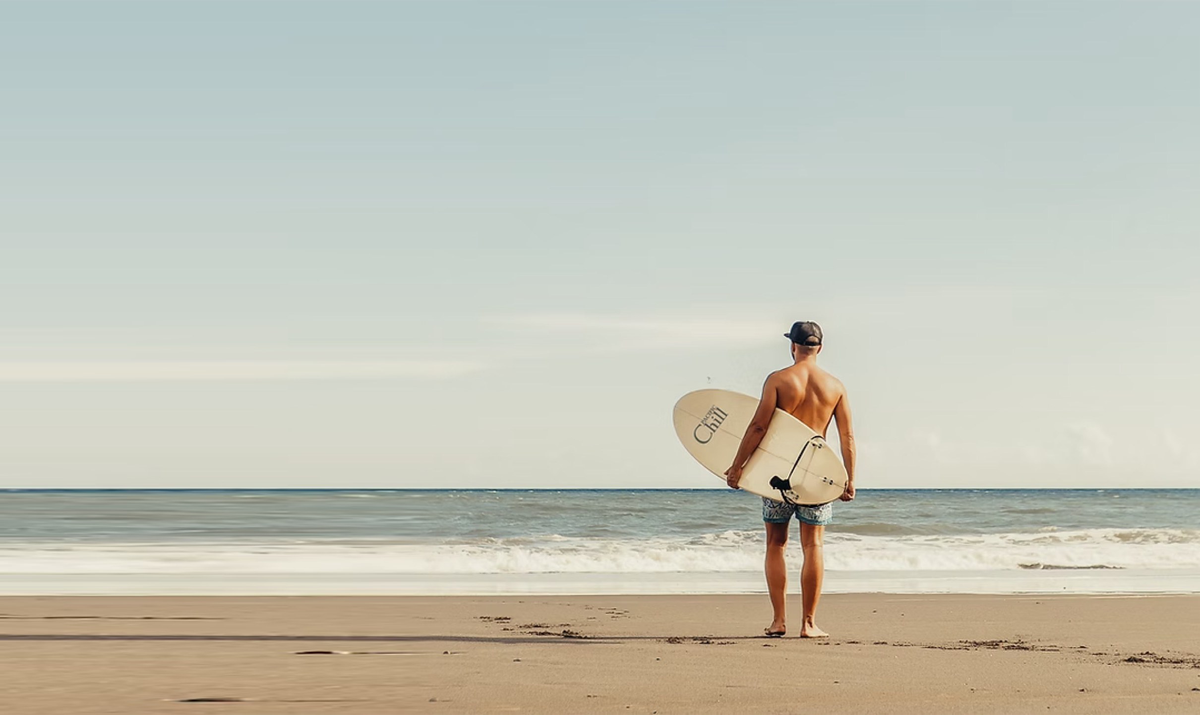 A surfer at the shoreline